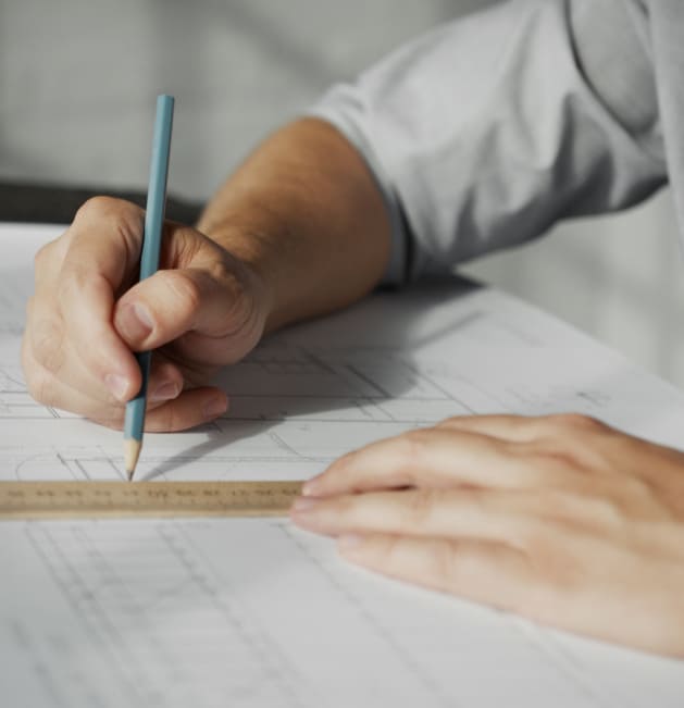 engineer-s-hands-drawing-a-construction-plan-2021-08-29-02-46-50-utc 1